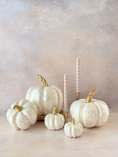 white pumpkins and candles on a table