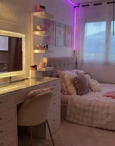 a bedroom with a bed, desk and mirror