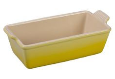 a yellow casserole dish on a white background