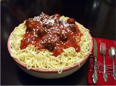 a bowl of spaghetti with meatballs and sauce