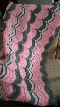 a crocheted blanket sitting on top of a chair