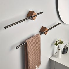 two towel racks are hanging on the wall