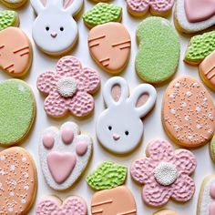 many decorated cookies are arranged on a table