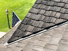 an american flag is on the roof of a house