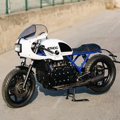 a white and blue motorcycle parked on the street