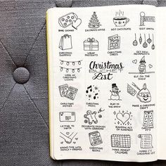 an open notebook with christmas stickers on it and the words'christmas list'written in cursive writing