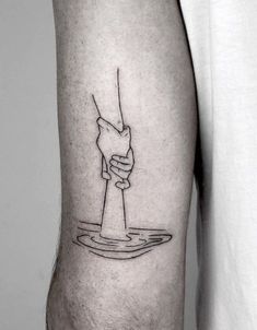 a black and white photo of a person's arm with a hand holding a water drop