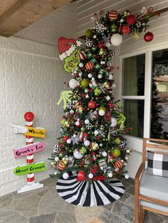 a decorated christmas tree in front of a house