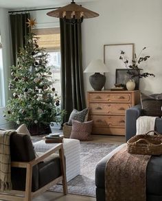 a living room filled with furniture and a christmas tree