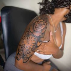 a woman with a clock tattoo on her arm