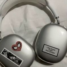 two silver headphones with pictures on them