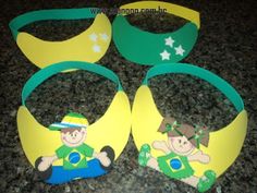 four green and yellow paper bracelets with cartoon characters on them sitting on a counter