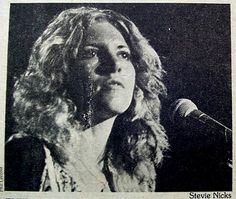 an old photo of a woman singing into a microphone