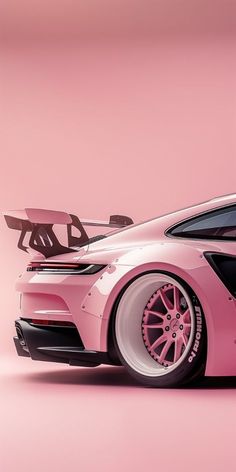 a pink sports car parked in front of a pink wall