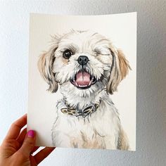 a person holding up a card with a drawing of a dog