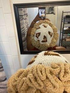 a person taking a photo of their reflection in a mirror with a stuffed animal on it's head