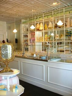 the inside of a pastry shop with lots of counter space