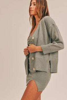 This 3-Piece Sweater Set includes a chic combination of a spaghetti strap crop top, a mini slit skirt, and a long sleeve button cardigan. The crop top offers a modern, stylish edge, while the mini slit skirt adds a touch of playful sophistication. The long sleeve cardigan provides a cozy, layered look that completes the ensemble. This versatile set can be dressed up or down for various occasions, perfect for transitioning between seasons. Enjoy the seamless blend of comfort and fashion with this Matching Top And Skirt, Olive Sweater, Spaghetti Strap Crop Top, Strap Crop Top, Cardigan Crop, Button Front Cardigan, Cropped Cami, Cable Knit Cardigan, Button Cardigan