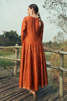 Burnt orange vegan silk anarkali with floral weaving pattern. Comes with pant and a dupatta. - Aza Fashions Unstitched Orange Anarkali Set For Festive Occasions, Orange Banarasi Silk Anarkali Set, Orange Raw Silk Anarkali Set With Resham Embroidery, Orange Chanderi Anarkali Set With Cutdana, Orange Art Silk Anarkali Set With Cutdana, Orange Anarkali Kurta With Zari Work, Orange Raw Silk Anarkali Set With Dupatta, Orange Silk Anarkali Salwar Kameez, Anarkali Silk Salwar Kameez In Orange