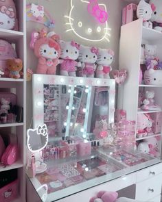 a hello kitty themed dressing table with lights and toys on it's shelves in a bedroom