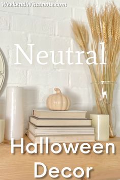 a table topped with books and candles next to a clock