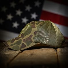 VINTAGE WWII FROG SKIN CAMO AMERICAN FLAG RANGE HAT 🇺🇸 Custom Cut & Sewn in America A must-have for range days, our range hats are built for shooters. The WWII vintage frog skin camo-inspired cotton twill fabric will protect your head from sharp brass while the buttonless crown will not interfere with ear protection or cause head pain. Vintage washed for that worn-in look and feel, our frog skin camo range hat is embroidered with an American flag on the front and our logo over the left ear. We Military Style Baseball Cap With Short Brim, Military Snapback Hat For Outdoor, Military Style Snapback Hat For Outdoor, Green Military Hat For Outdoor Activities, Military Style Snapback Hat With Curved Brim For Outdoor, Military Green Hat For Outdoor Activities, Military Style Snapback Hat With Curved Brim, Tactical Outdoor Cap Hat, Tactical Outdoor Cap