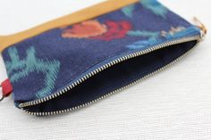 The perfect sized clutch purse to carry your phone, cash, cards, lip balm, keys and more. The zipper closure will keep your items safe and secure, yet easy for you to access!    Product features:- one of a kind- made from upcycled materials - fully lined- metal loop tab for easy attaching to other bags/belts- concealed French seams- durable finish  Size:7" - 4.5" Care instructions:Gentle machine or hand wash recommended when needed.  Please note: pattern placement of fabric may change. These clu Bohemian Cosmetic Bag With Zipper, Rectangular Shape, Bohemian Cosmetic Bag, Rectangular Zipper Pouch, Bohemian Rectangular Cosmetic Bag With Zipper, Bohemian Style Rectangular Cosmetic Bag With Zipper, Bohemian Rectangular Cosmetic Bag For Daily Use, Bohemian Cosmetic Bag For Daily Use, Bohemian Zipper Pouch Clutch For Daily Use, Rectangular Clutch With Zipper Pocket, Blue Bohemian Pouch For Everyday Use