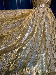 a gold and silver dress with sequins on it