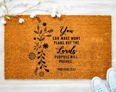 a door mat with the words you can make many plans but the lord's purpose will prevail