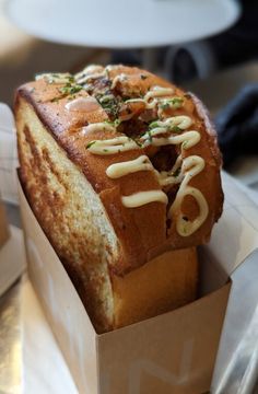 a loaf of bread sitting in a box on top of a table