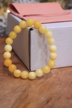 A yellow jasper bracelet typically features smooth, rounded beads showcasing the stone's warm, golden hues. Jasper is known for its nurturing properties, promoting balance and positivity. This bracelet can be both aesthetically pleasing and potentially carry the perceived metaphysical benefits associated with yellow jasper. Elegant Yellow Stretch Bracelet With Round Beads, Elegant Yellow Beaded Stretch Bracelet, Elegant Yellow Stretch Bracelet, Yellow Bracelets With Natural Stones, Yellow Natural Stones Round Bracelets, Elegant Yellow Bracelets With 8mm Beads, Women Healing, Spina Bifida, Yellow Jasper