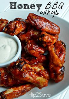 chicken wings with ranch dressing on a white plate