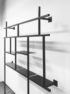 a black and white photo of shelves on the wall