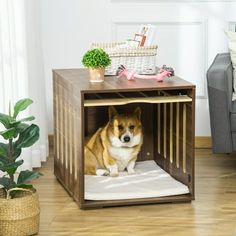 a dog is sitting in his crate on the floor