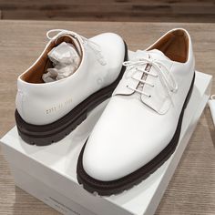 White Leather Derbys Buffed Leather Derbys In White. Lace-Up Closure Padded Tongue And Collar Gold-Tone Serial Number Stamp At Outer Side Treaded Rubber Sole In Brown Supplier Color: White Upper: Leather. Sole: Rubber. Made In Italy. Retail Price: $660 Classic White Leather Work Shoes, Classic White Leather Shoes For Work, Elegant White Leather Shoes With Branded Heel Counter, Elegant White Leather Shoes With Branded Heel, White Leather Business Shoes With Leather Lining, White Leather Business Shoes, Luxury White Leather Office Shoes, Luxury White Calf Leather Shoes, White Calf Leather Plain Toe Shoes