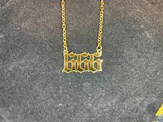 Dark times call for Darkness Jewelry. This custom-made 666 Mark of the Beast Pendant Necklace in Old English font is truly a sight to behold! Made of solid, deep-cut, stainless steel in gold color. Chain is adjustable and is also made of gold-colored stainless steel. Show your support of The One behind all of this madness and be saved when He sets foot upon the land. Material: Stainless Steel, Steel Color: Gold Dimensions: Necklace length = 19 inches, Pendant height = 12 millimeters, Pendant... 666 Number, Metal Pendant Necklace, Old English Font, Metal Pendant, Old English, The Beast