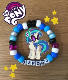 the pony bracelet has been made with beads and plastic letters that spell out its name