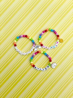 Adorable kids beaded bracelet with 6mm bright rainbow beads with your choice of name/lettering and charm. So cute and the charm adds such a unique look to your little one's bracelet! You can also choose not add a charm and just a name/word. Makes a great gift as well- everyone loves something personalized! Please provide the following information in the personalization field: -Name/word you would like -Heart color (if any)- red, orange, yellow, green, blue, purple, pink, black or gold -SIZING ** Kids Bead Bracelet, Name Lettering, Bright Rainbow, Green Blue Purple, Rainbow Beads, Red Orange Yellow, Heishi Beads, Personalised Kids, Pink Heart