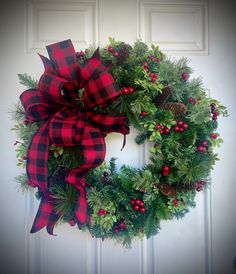 a christmas wreath hanging on the front door