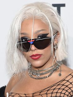 lady with white hair and black sunglasses at an event