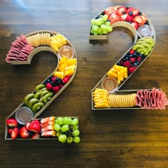 the number twenty two made out of fruits and veggies on a wooden table