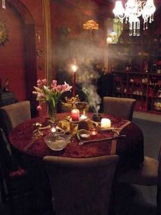 a dining room table with candles and flowers on it