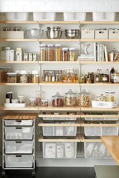 the pantry is stocked with lots of food and containers on shelves that are labeled grocers