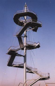 a tall metal structure with stairs on top