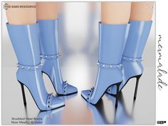 a pair of blue high heeled boots with studs on the toes and ankles