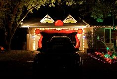 a car parked in front of a house covered in christmas lights