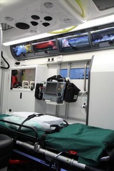 an empty hospital room with medical equipment on the bed and in the background is television screens