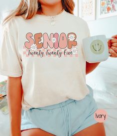 This retro Senior 2025 shirt by Comfort Colors is as trendy as it is comfortable! It would be a great gift for the soon to be 2025 high school graduate in your life! COMFORT COLORS DETAILS: .: Soft-washed, garment-dyed fabric  .: Double-needle stitching throughout  .: 100% ring-spun cotton .: Medium fabric (6.1 oz/yd² (206.8 g/m .: Relaxed fit .: Sewn-in twill label CARE INSTRUCTIONS: .:Machine wash cold; do not bleach. Dry on low heat or lay flat to dry; do not dry clean. SIZING .:This is a rel Senior Year T Shirt Ideas, Senior Shirt Ideas 2023 Trendy, Cute School Shirt Designs, Senior T Shirt Designs, Cute School Shirts, 2024 Senior Ideas, Senior Year 2024, Senior Shirt Ideas 2024