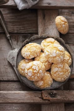 powdered sugar cookies in a bowl on a wooden table