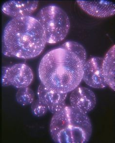 many bubbles floating in the air on a black background